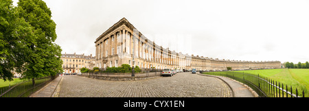 BATH, UK - A high resolution panorama of Royal Crescent, an historic row of well-to-do houses in Bath, Somerset, United Kingdom. The Royal Crescent is a street of 30 terraced houses laid out in a sweeping crescent in the city of Bath, England. Designed by the architect John Wood the Younger and built between 1767 and 1774, it is among the greatest examples of Georgian architecture to be found in the United Kingdom and is a Grade I listed building. Although some changes have been made to the various interiors over the years, the Georgian stone façade remains much as it was when it was first bui