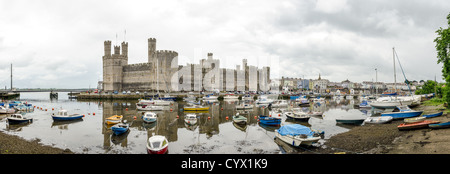 CAERNARFON, Wales — Panorama of exterior of Caernarfon Castle in northwest Wales. A castle originally stood on the site dating back to the late 11th century, but in the late 13th century King Edward I commissioned a new structure that stands to this day. It has distinctive towers and is one of the best preserved of the series of castles Edward I commissioned. Stock Photo