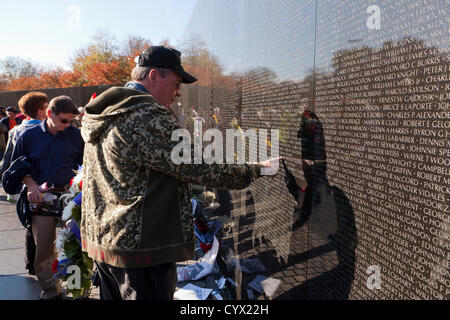 November 11, 2012: A Vietnam veteran touches the inscribed name of a fallen solder on the Vietnam War Memorial - Washington, DC USA Stock Photo