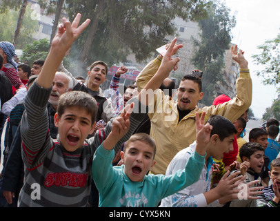 People participate in a anti-Assad street protest in Maade. Free Syrian Army members provided protection and support. Stock Photo