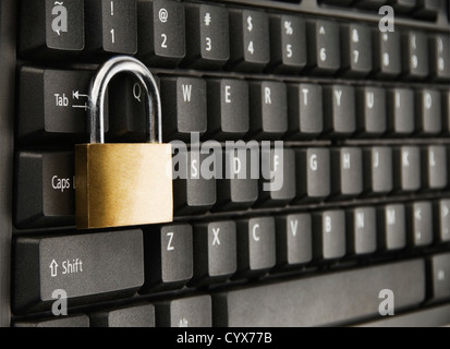 Padlock on a computer keyboard Stock Photo