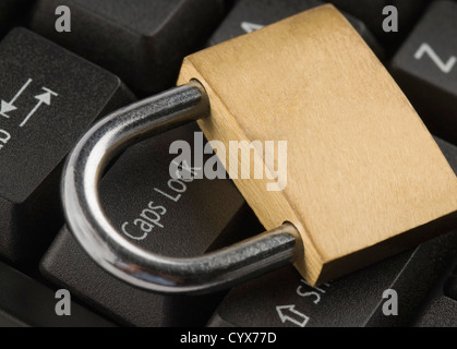 Padlock on a computer keyboard Stock Photo