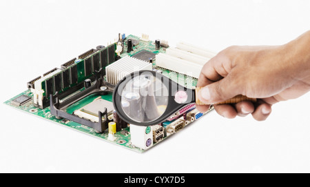 Human hand holding magnifying glass over a circuit board Stock Photo