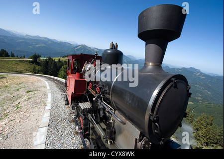 An old steam locomotive is climbing up the 'schafbergbahn' on to the top of the Schafberg (1783 meters) in Austria. Stock Photo