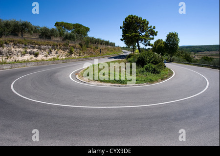 A hairpin bend on a road in the mountains of Toscany in Italy Stock Photo