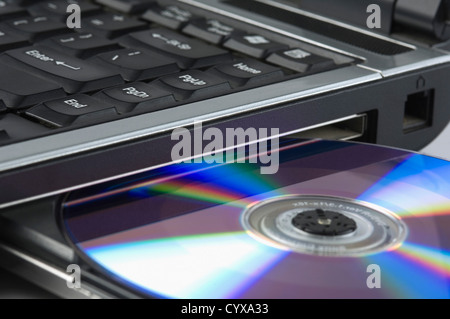 Close-up of a laptop ejecting a CD Stock Photo