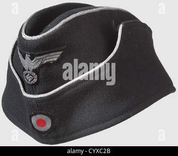 A garrison cap to the black special uniform,for officers of Panzer troops Garrison cap of fine gabardine material with continuous silvered cording of spun aluminum in the ca. 1942 officerïs issue without soutache. Silver woven eagle and Reich cockade stitched on in front. Black cotton liner with 58 size stamping. In never worn top condition,historic,historical,1930s,20th century,armoured corps,armored corps,tank force,tank forces,branch of service,branches of service,armed service,armed services,military,militaria,utensil,piece of equipment,ut,Additional-Rights-Clearences-Not Available Stock Photo