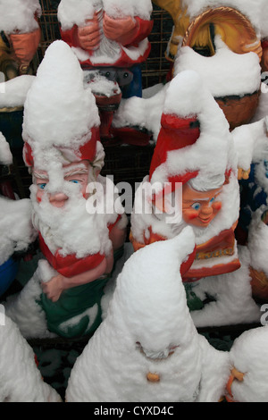 ceramic garden gnomes at display in shop outside in winter covered by snow. Photo by Willy Matheisl Stock Photo