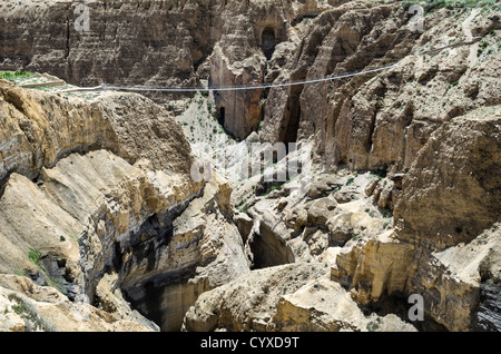 The bridge across the deep canyon near Ghyakar village. Asia Asian Nepalese Stock Photo