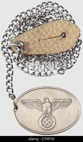 A warrant disc and photo album,for a member of GESTAPO Oval nickel-silver badge,with a raised national eagle on front and 'GEHEIME STAATSPOLIZEI' in raised letters on back with number '5515' on a raised section below.Dimensions 37 x 51 cm.Weight 25.61 g.With iron chain and button attachment.It comes with a photo album with more than 150 pictures mostly from owner's period in 'SD' during invasion of Austria and Polish campaign,containing some horrifying pictures of arrest of Jews and Poles.Very interesting uniform details ,Additional-Rights-Clearences-Not Available Stock Photo