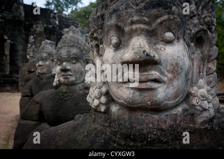 Detail of row of Demon statutes at the gate to Prasat Bayon temple complex  Angkor Wat, SIEM REAP, CAMBODIA World Heritage Site Stock Photo