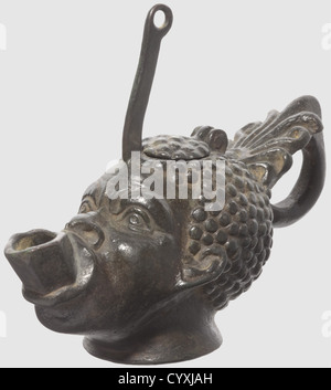 A Roman bronze oil lamp, in the shape of a moor's head, 1st/2nd century AD. Bronze with dark green patina. Naturalistically crafted body with octagonal spout and an elaborately shaped ring handle. Slender suspension ring on top. Length 10.5 cm. Provenance: Munich private collection, ca. 1990, historic, historical, ancient world, ancient world, ancient times, object, objects, stills, clipping, cut out, cut-out, cut-outs, mediterranean, precious metal, precious metals, Additional-Rights-Clearences-Not Available Stock Photo