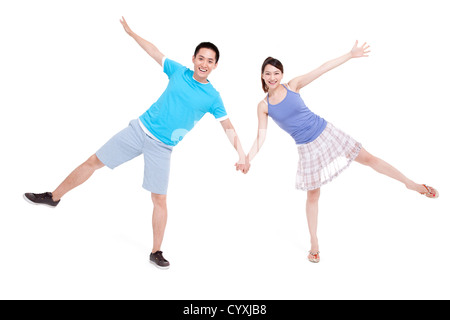 Excited young couple spread-eagled Stock Photo - Alamy