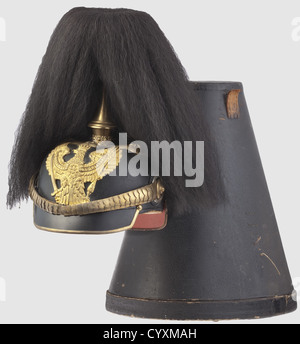 A helmet for officers,of Prussian Line Dragoon Regiments Leather shell with gilt fittings,officer's cockade. Personal property helmet with owner's name "Werther",the body slightly sunken in. Dove grey silk liner,green/red coated visors,the rear visor loose,held by rear rail. Sweat band with maker"s mark "Superior". Vaulted chin scales,the leather chin strap with metal toggle,eyelet and closure complete and present. Black parade bison hair tuft on a long point with well preserved gilding. Helmet size "58 1/2"marked inside,complete with storage box(dama,Additional-Rights-Clearences-Not Available Stock Photo