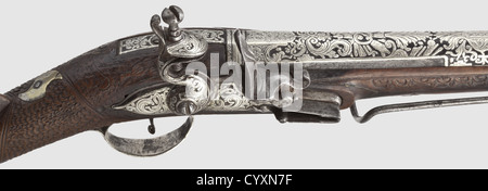 An Ottoman silver-inlaid flintlock blunderbuss,19th century Two-stage barrel,octagonal then round,with slightly belled muzzle. The top of the barrel with ornamental silver inlays in good condition,some of them finely engraved. En suite silver-inlaid flintlock. The wooden stock with scale-shaped carvings and silver furniture. Screwed,iron staple with silver-inlaid tendrils on the side plate. Length 69 cm. Beautiful workmanship,historic,historical,19th century,Ottoman Empire,firearm,fire arm,gun,fire arms,firearms,guns,handgun,weapon,arms,weapo,Additional-Rights-Clearences-Not Available Stock Photo