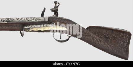 An Ottoman silver-inlaid flintlock blunderbuss,19th century Two-stage barrel,octagonal then round,with slightly belled muzzle. The top of the barrel with ornamental silver inlays in good condition,some of them finely engraved. En suite silver-inlaid flintlock. The wooden stock with scale-shaped carvings and silver furniture. Screwed,iron staple with silver-inlaid tendrils on the side plate. Length 69 cm. Beautiful workmanship,historic,historical,19th century,Ottoman Empire,firearm,fire arm,gun,fire arms,firearms,guns,handgun,weapon,arms,weapo,Additional-Rights-Clearences-Not Available Stock Photo