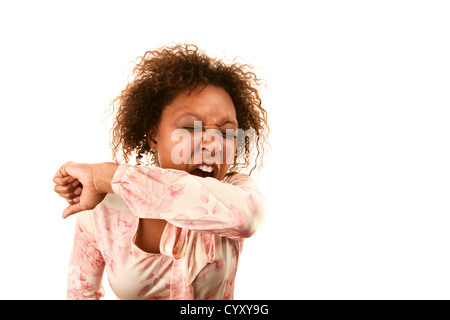 Young woman sneezing into her sleeve to prevent disease spread Stock Photo