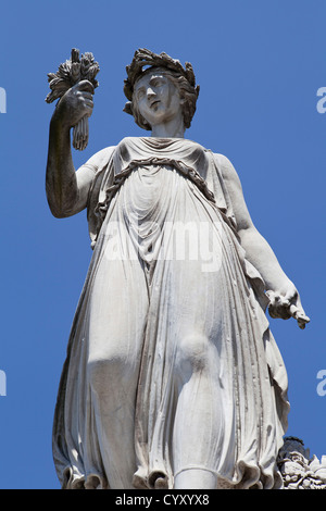 Italy, Lazio, Rome, Statue of a female figure at the Piazza del Popolo with a blue sky. Stock Photo
