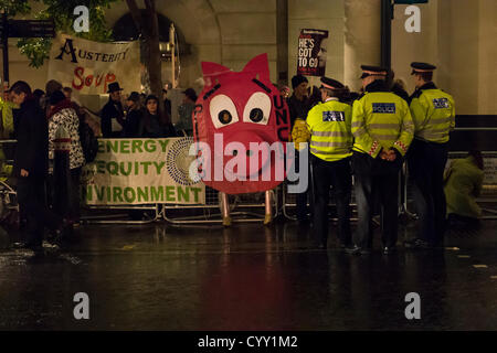 12th November 2012, Guildhall, London, UK. As the Lord Mayor of London holds a banquet for the bankers and business people of The City, a protest against the austerity cuts takes place opposite. Named PIIGS and Plebs of London. PIIGS are the people of Portugal, Italy, Ireland, Greece and Spain, those countries suffering the most due to the cuts. Stock Photo