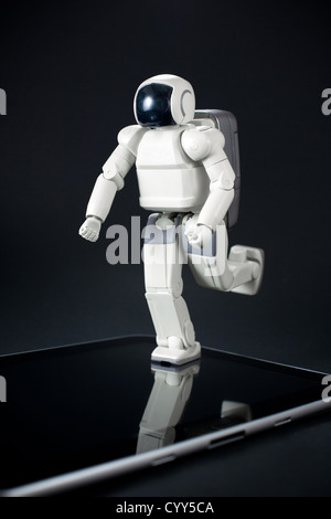 Concept of future - toy robot and modern tablet computer Stock Photo