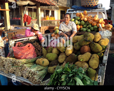 Woman selling jack fruits in open air food market in Pasar Kumbasari Denpasar Bali Indonesia Stock Photo