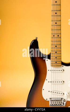 Electric guitar detail with orange lighting. Stock Photo