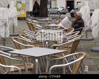 Old man reading newspaper Stock Photo