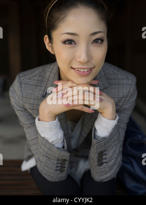 Beautiful young Japanese woman visiting Meiji Jingu Shrine, Tokyo Stock Photo