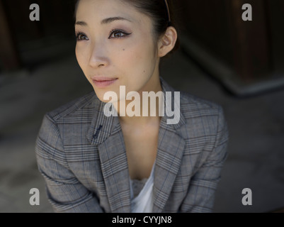 Beautiful young Japanese woman visiting Meiji Jingu Shrine, Tokyo Stock Photo