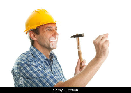 Confident worker hammering in Stock Photo