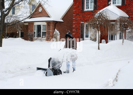 Man clearing snow from driveway Stock Photo