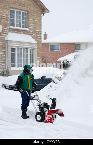 Man clearing snow from driveway Stock Photo