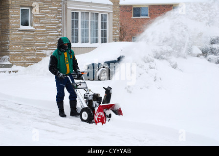 Man clearing snow from driveway Stock Photo