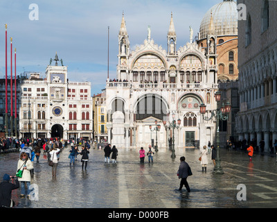 Italy, Venice, Basilica San Marco and Torre dell'Orologio under flood water, with tourists Stock Photo