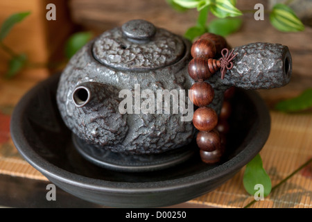 Chinese teapot and prayer beads Stock Photo