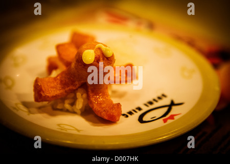 A plate of food that looks like an octopus in a Sushi King restaurant, Malaysia Stock Photo