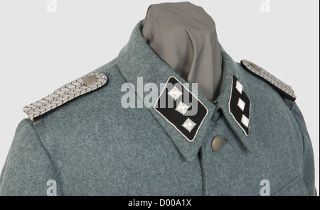 A field tunic for a 'Zugführer' of Technical Emergency Service,of police green woolen cloth,the hip pockets with double folds,field grey buttons,TeNo acceptance stamping and size stamp '46' inside green silk liner.Black collar tabs with continuous silver braid and insignia of rank on each side,looped shoulder boards and liner shot through with black,silver-embroidered police sleeve eagle,machine-embroidered traditional TeNo sleeve lozenge.Very rare field tunic with insignia introduced by Himmler in 1944 so as to standardise rank insignia of the,Additional-Rights-Clearences-Not Available Stock Photo