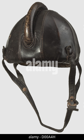 A pilot's flight protection helmet model SSK 90,Body of riveted steel plates with brown leather covering(damage)and bulged cranium. Straps with push-button attachment(rusty). Sand-coloured cotton textile liner with damaged maker's label "Siemens - Baumuster SSK 90 - Hersteller Luftfahrtgerätewerk Hakenfelde GMBH". Soiled,historic,historical,1930s,1930s,20th century,Air Force,branch of service,branches of service,armed service,armed services,military,militaria,air forces,object,objects,stills,clipping,clippings,cut out,cut-out,cut-outs,,Additional-Rights-Clearences-Not Available Stock Photo