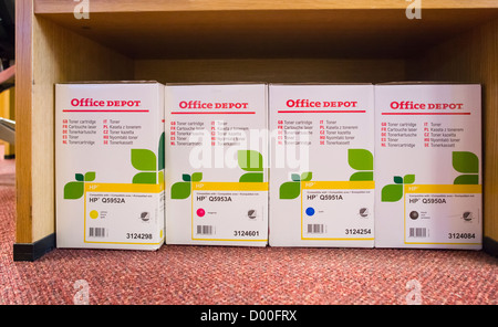 Boxes of HP printer cartridges from Office Depot on an office floor. Stock Photo