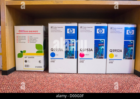 Boxes of HP printer cartridges on an office floor. Stock Photo