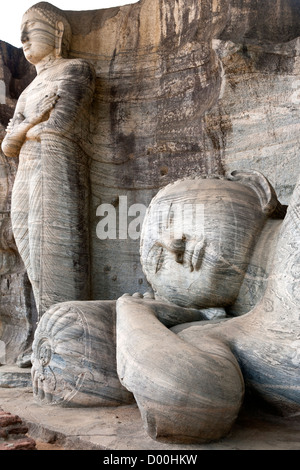 Reclining Buddha and standing Buddha carved on the rock. Gal Vihara. Polonnaruwa ancient city. Sri Lanka Stock Photo