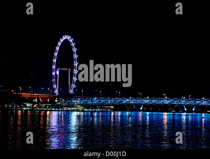 Singapore flyer and helix bridge on Marina Bay, Singapore, at night Stock Photo