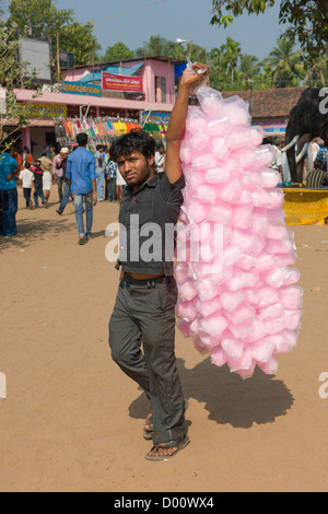 Man selling bags of pink candy floss at the Goureeswara Temple Festival, Cherai, near Kochi (Cochin), Kerala, India Stock Photo