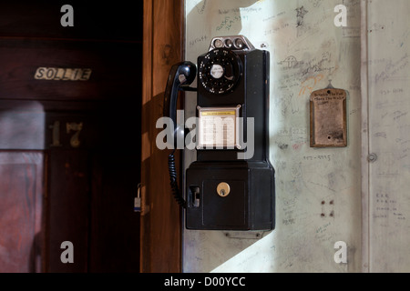 Antique pay phone on wall Stock Photo