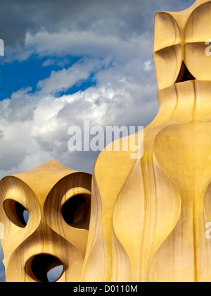 Ventilation towers or chimneys on the roof of La Pedrera or Casa Mila designed by Antoni Gaudi in Barcelona city centre Spain Stock Photo