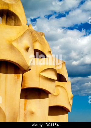 Ventilation towers or chimneys on the roof of La Pedrera or Casa Mila designed by Antoni Gaudi in Barcelona city centre Spain Stock Photo