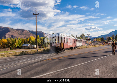 1925 Baldwin Steam Locomotive, 2-8-2 configuration, Mikado type, pulling historic classic railcars crossing US 550 highway 1925 Baldwin Steam Locomotive, 2-8-2 configuration, Mikado type, pulling historic classic railcars crossing US 550 highway