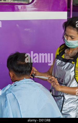 Cutting Hairs on a Platform of the Central Railway Station in Bangkok, Thailand Stock Photo