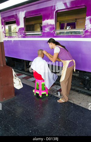 Cutting Hairs on a Platform of the Central Railway Station in Bangkok, Thailand Stock Photo