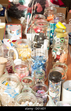 jars  of different types of buttons and accessories for sewing Stock Photo